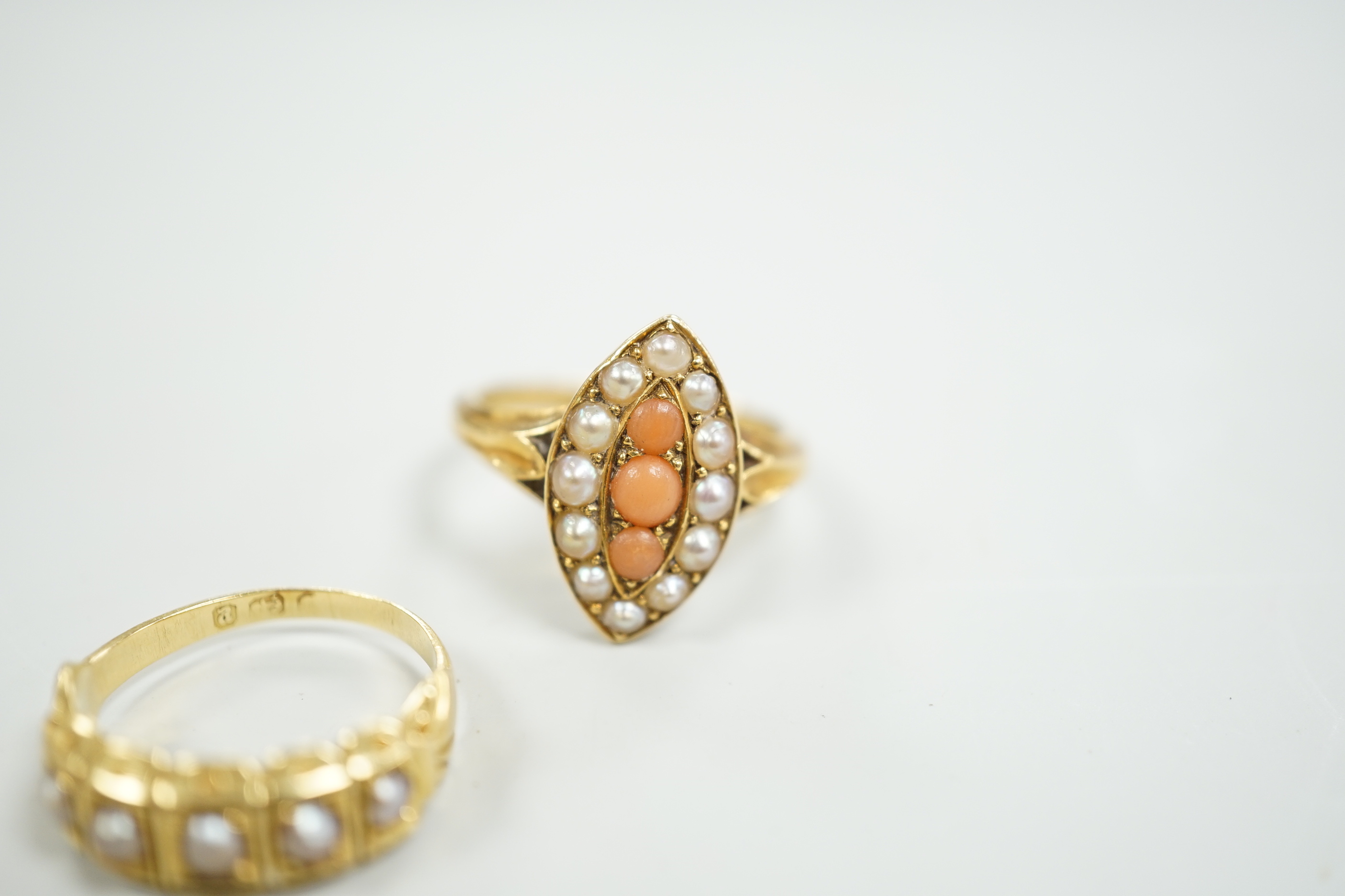 A late Victorian yellow metal, split pearl and coral set marquise shaped ring, size L and a similar yellow metal and split pearl set half hoop ring, gross weight 8 grams.